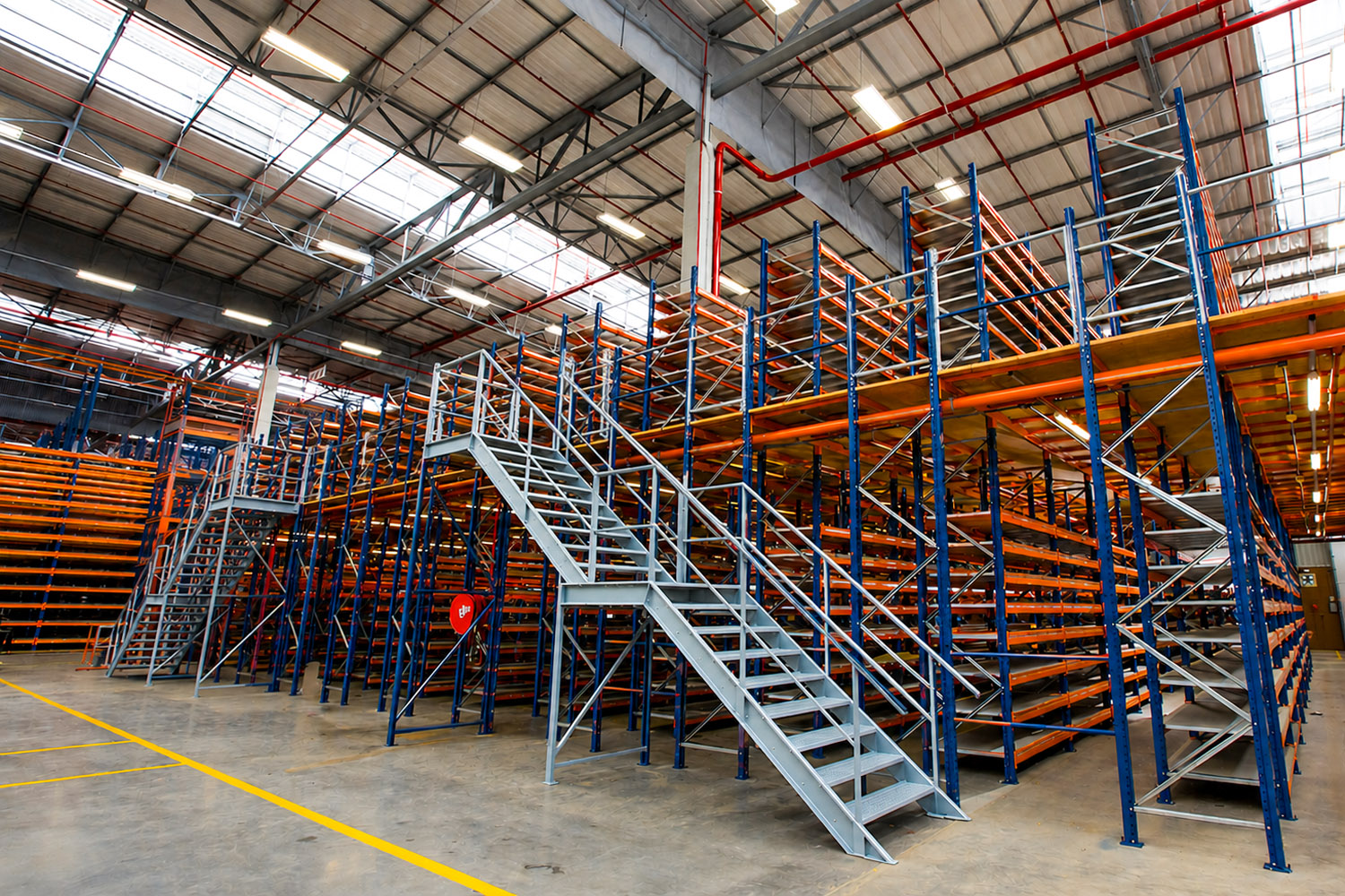 Industrial steel warehouse racking mezzanine floor system installed in a logistics facility